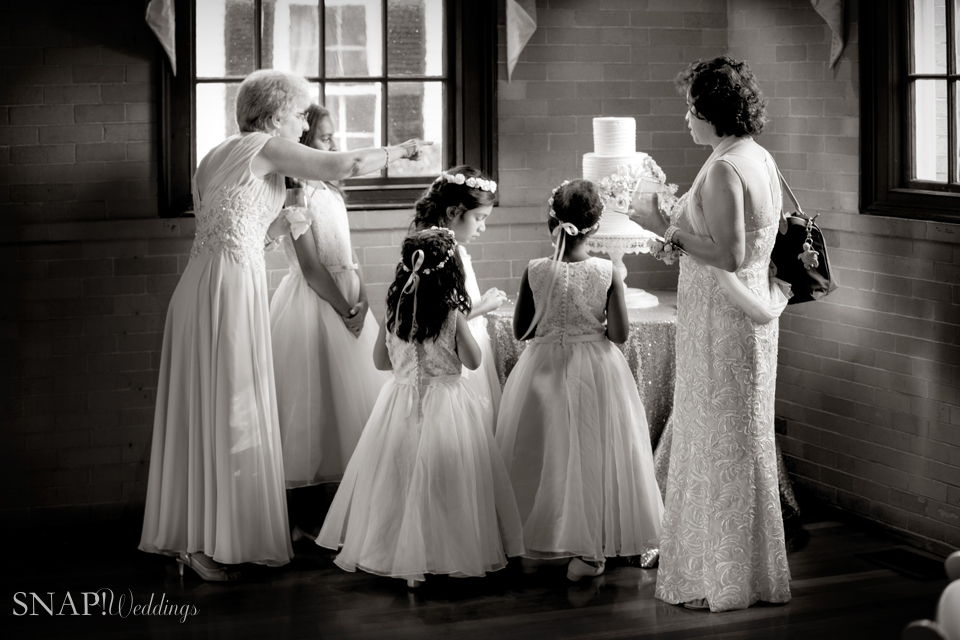 Flower Girls admire the wedding cake at a Linden Place wedding reception