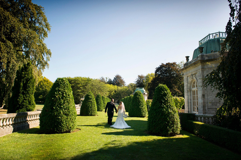 bride and groom stroll the grounds at The Elms Mansion