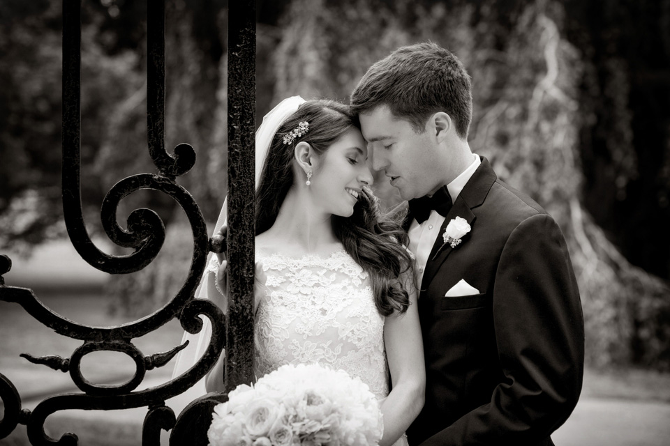 Bride and Groom with Ornate Gates at The Elms Mansion